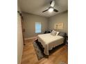 This bedroom features wood floors, a ceiling fan, a large bed, and a barn door at 6725 Grove Meadows Ln, Cumming, GA 30028