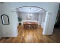 Spacious dining room with hardwood floors, decorative molding, and an elegant chandelier at 6725 Grove Meadows Ln, Cumming, GA 30028
