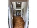 Elegant entryway with hardwood floors, high ceilings, a chandelier, and a staircase leading to the upper level at 6725 Grove Meadows Ln, Cumming, GA 30028