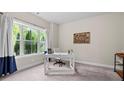 Bright office with a large window and natural light, a desk, and neutral decor at 1914 Forte Ln, Alpharetta, GA 30009