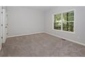 Neutral bedroom with large window allowing natural light and plush carpet at 2173 Pebble Beach Dr, Lawrenceville, GA 30043