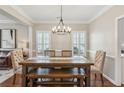 Elegant dining room with stylish chandelier, wood table, and white molding, perfect for gatherings at 2713 Stillwater Lake Ln, Marietta, GA 30066