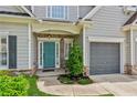 Inviting front entrance with a teal door, brick accents, and a well-maintained lawn, offering great curb appeal at 2713 Stillwater Lake Ln, Marietta, GA 30066