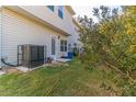 View of the exterior and backyard with A/C unit at 7162 Fringe Flower Dr, Austell, GA 30168