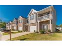 Inviting townhome community featuring manicured lawns and attached garages at 7162 Fringe Flower Dr, Austell, GA 30168