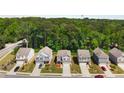 Aerial view of a neighborhood featuring well-maintained homes with lush greenery and mature trees at 9007 Jim Purcell Dr, Covington, GA 30014
