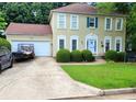 Charming two-story home with attached garage and well-manicured lawn at 215 Boca Ciega Ct, Alpharetta, GA 30022