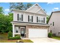 Attractive two-story house features stone accents and black shutters, enhancing curb appeal at 2939 Woodward Down Trl, Buford, GA 30519