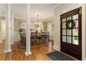 Elegant dining room with hardwood floors, classic columns, and stylish chandelier at 4404 Old Georgetown Trl, Atlanta, GA 30338