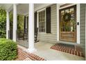 Inviting front porch with rocking chairs and classic architectural details at 4404 Old Georgetown Trl, Atlanta, GA 30338