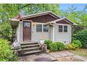 Inviting home with well-manicured front yard and a cozy, classic facade at 677 Holmes Nw St, Atlanta, GA 30318