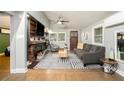 Bright living room featuring a sleek fireplace, modern furnishings, and hardwood floors at 677 Holmes Nw St, Atlanta, GA 30318