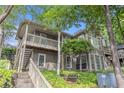 Two-story condo featuring a staircase entry, private balcony, and lush greenery at 2105 Country Park Se Dr, Smyrna, GA 30080