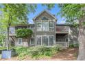 Charming two-story home with multiple windows and balconies surrounded by mature trees and lush landscaping at 2105 Country Park Se Dr, Smyrna, GA 30080