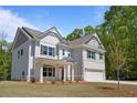 Charming home showcases a combination of brick and siding, complemented by well-maintained landscaping and an attached garage at 2749 Porches Ln, Dacula, GA 30019