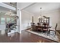 Elegant dining room featuring hardwood floors, an ornamental chandelier, and a spacious dining set at 390 Scott Farm Dr, Powder Springs, GA 30127