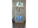 High angle view of foyer with modern chandelier, hardwood floors, and a double-door entrance at 4010 Sierra Knolls Ct, Cumming, GA 30040