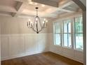 Elegant dining room with coffered ceiling, wainscoting, and large windows at 4050 Sierra Vista Cir, Cumming, GA 30040