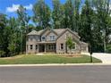 Beautiful two-story home with brick facade, well-manicured lawn, and mature trees in a desirable neighborhood at 4050 Sierra Vista Cir, Cumming, GA 30040