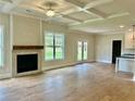 Bright living room featuring a fireplace, coffered ceiling and access to the backyard at 4050 Sierra Vista Cir, Cumming, GA 30040