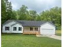 Charming single-story home with white siding, black shutters, a front porch, attached garage, and a well-maintained lawn at 201 Deerfield Ln, Carrollton, GA 30116