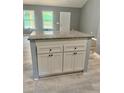 New kitchen island with granite countertop and grey cabinets gives a homey and simple yet modern vibe at 201 Deerfield Ln, Carrollton, GA 30116