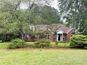 Traditional brick home on a landscaped lot with mature trees and a well-maintained lawn at 300 Gaelic Way, Tyrone, GA 30290