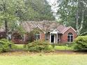 Charming brick home with a well-manicured lawn and beautiful landscaping at 300 Gaelic Way, Tyrone, GA 30290