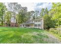 Well-manicured lawn surrounds this lovely two-story home with classic architectural details at 4367 Cedar Wood Sw Dr, Lilburn, GA 30047
