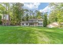 Charming two-story home with lush green lawn and mature trees providing shade and privacy at 4367 Cedar Wood Sw Dr, Lilburn, GA 30047