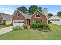 Inviting brick home boasting a neat lawn and colorful flower beds at 4730 Fairway View Ct, Duluth, GA 30096