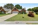 Lovely brick home featuring a well-maintained lawn and established landscaping at 4730 Fairway View Ct, Duluth, GA 30096