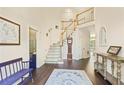 Inviting foyer with hardwood floors, staircase, and decor at 946 Cornwall Sw Ct, Marietta, GA 30064
