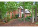 Charming two-story brick home with a well-manicured lawn and mature trees at 946 Cornwall Sw Ct, Marietta, GA 30064