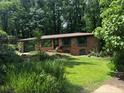 Charming brick home features a well-manicured lawn, landscaping, and an attached garage at 1094 Seville Dr, Clarkston, GA 30021