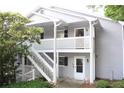 Exterior view of condo featuring white trim, steps, and nice landscaping at 1105 Natchez Trce, Atlanta, GA 30350