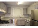 The kitchen features stainless steel appliances and gray cabinets at 1105 Natchez Trce, Atlanta, GA 30350