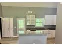 Bright kitchen with white cabinets, granite counters, and a spacious island, perfect for entertaining at 191 Deerfield Ln, Carrollton, GA 30116