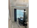 Elegant dining room featuring modern chandelier, large windows, and stylish wood flooring at 3006 Fairway Dr, Villa Rica, GA 30180
