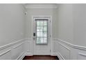 Welcoming entryway featuring classic wainscoting, neutral paint, and wood flooring at 3123 Cross Creek Dr, Cumming, GA 30040