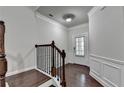 Elegant entryway with a staircase, wainscoting, dark wood floors, and a front door at 3123 Cross Creek Dr, Cumming, GA 30040