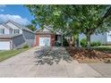 Charming brick home with a one-car garage and driveway, complemented by mature landscaping at 152 Stoneforest Dr, Woodstock, GA 30189