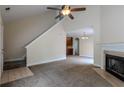 Bright living room featuring a fireplace, vaulted ceilings with fan, and access to the outdoor deck at 152 Stoneforest Dr, Woodstock, GA 30189