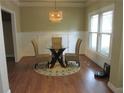 Cozy dining area with stylish lighting, hardwood floors, and a view of the outdoors at 1527 Princeton Ave, College Park, GA 30337