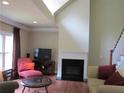 Bright living room with a fireplace, comfortable seating, and a large window for natural light at 1527 Princeton Ave, College Park, GA 30337