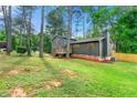 Charming home featuring wood siding, shutters, stone foundation, with a well-maintained lawn and a new fence at 256 Grist Mill Ln, Lawrenceville, GA 30046
