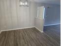 A dining room featuring gray walls, wood floors, and a contemporary light fixture at 3201 Fairington Dr, Lithonia, GA 30038