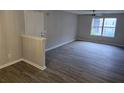 A bright living room with gray walls, wood floors, a modern ceiling fan, and natural light from the windows at 3201 Fairington Dr, Lithonia, GA 30038
