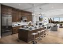 Modern kitchen with stainless steel appliances, white countertops, dark wood cabinetry, and an island with seating at 2052 Lanier Grv, Alpharetta, GA 30009
