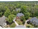 Aerial view of a secluded home surrounded by mature trees in a lovely neighborhood at 330 Broad Leaf Ct, Johns Creek, GA 30022